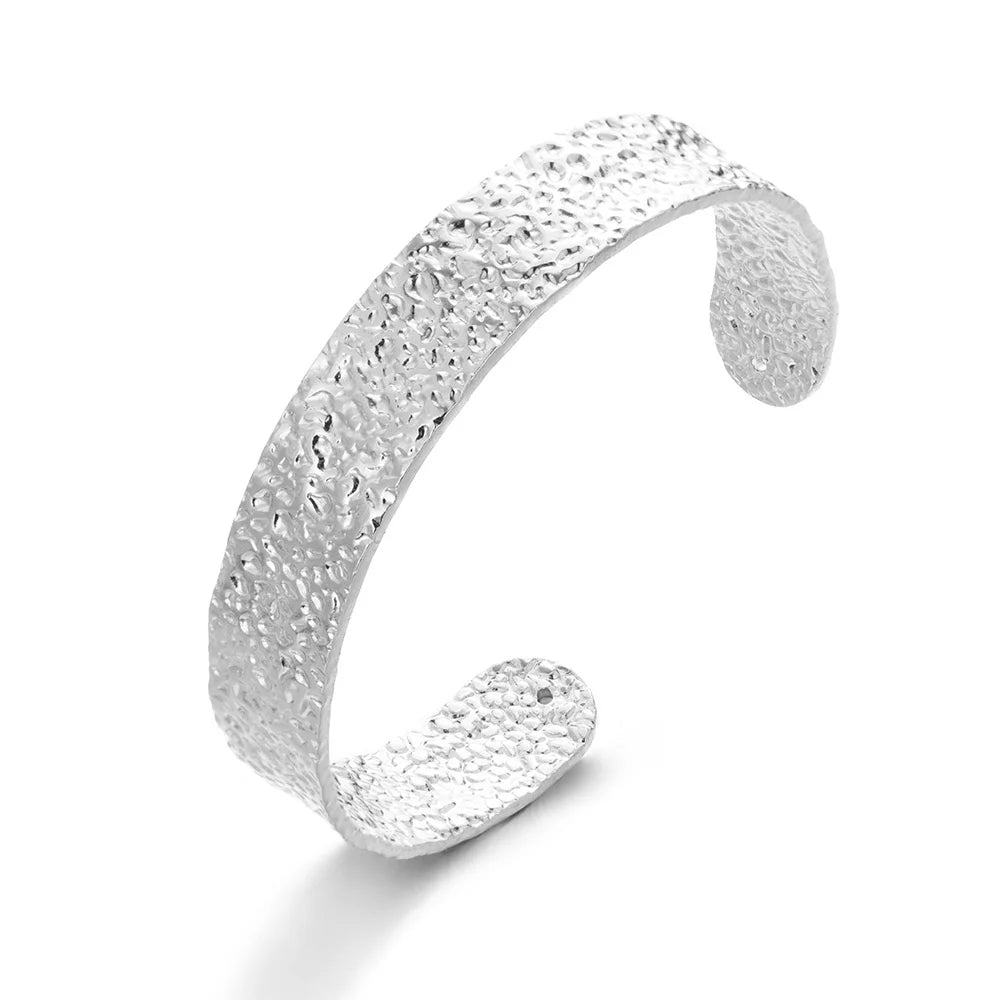 Silver textured bracelet on a white background