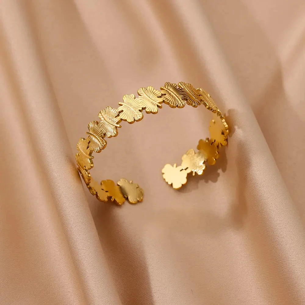 Gold leaf bracelet on a beige fabric background