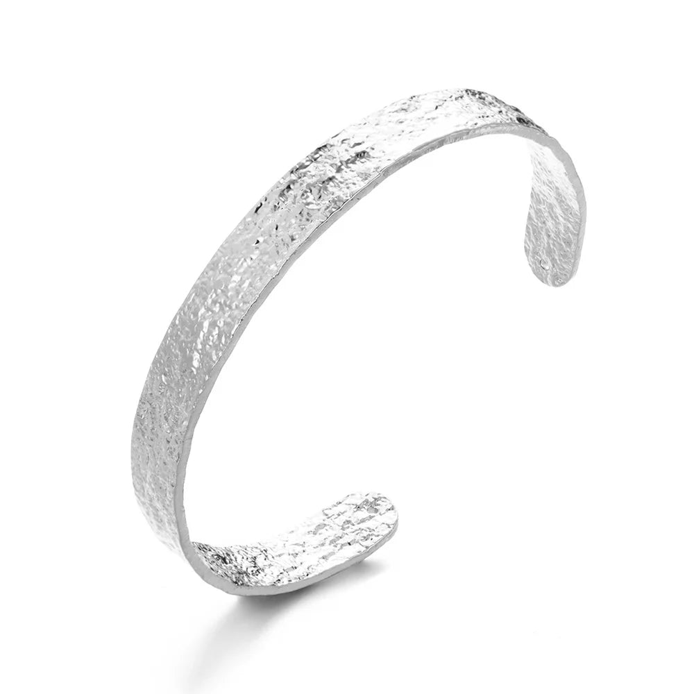 Silver textured bracelet on a white background