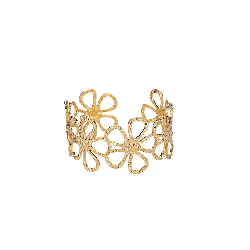Gold floral cuff bracelet on a white background